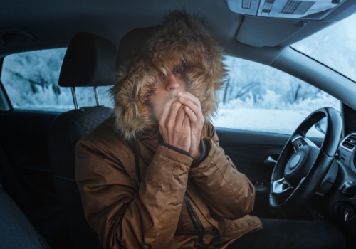 Man warming up inside car