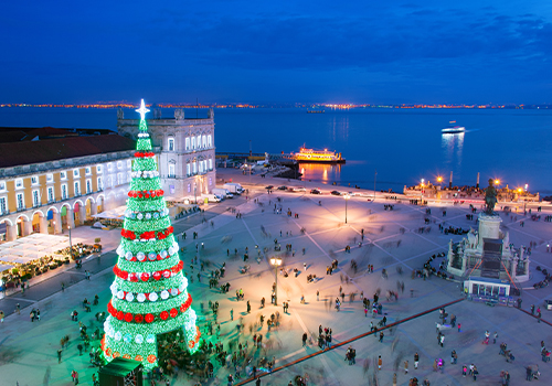 Night in Lisbon's Terreiro do Paço, decorated with lights and a Christmas tree