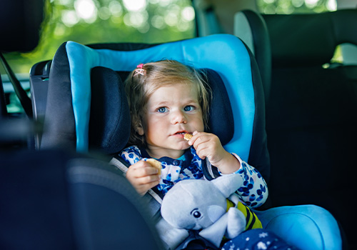 baby with blue eyes sitting in car