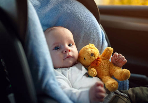 baby boy sitting in car seat child transportation